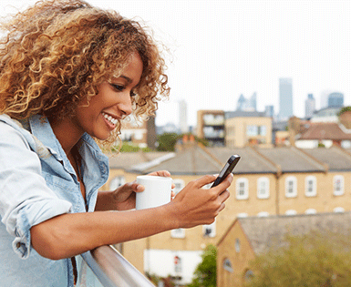 Woman on her cellphone smiling 