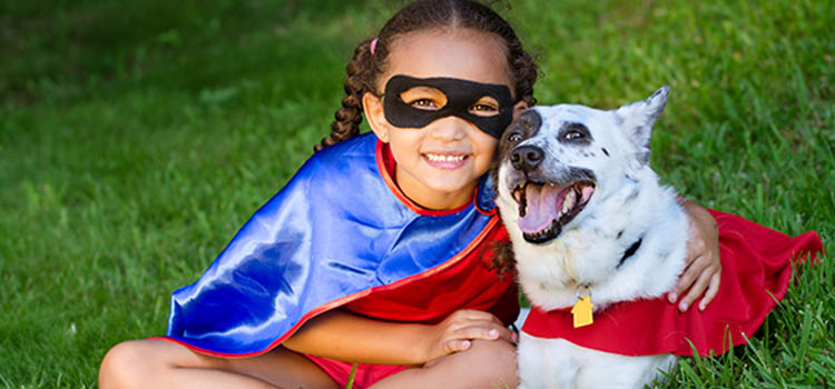 Happy girl and her dog dressed for Halloween